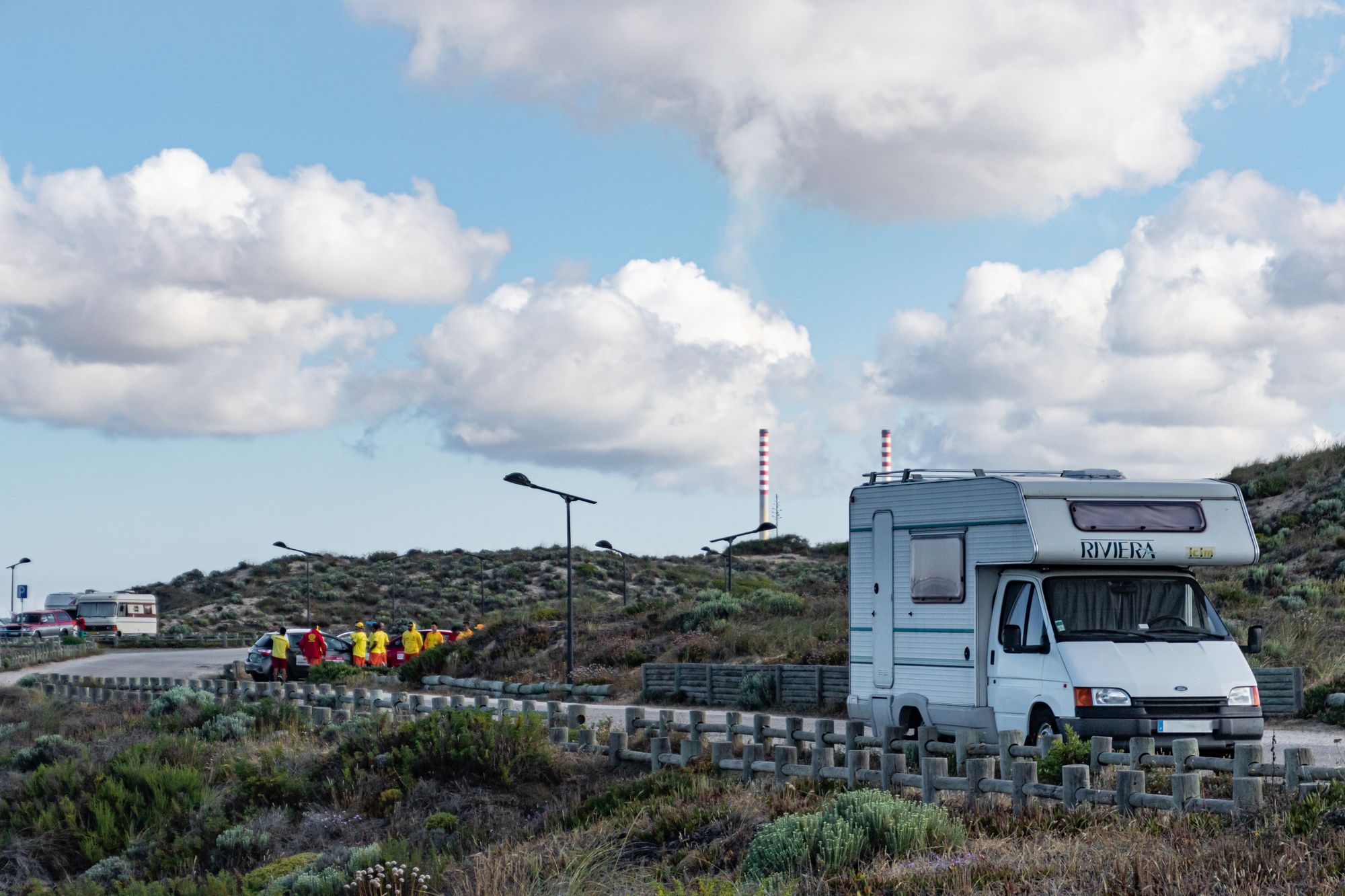 A campervan parked in a scenic landscape under a blue sky